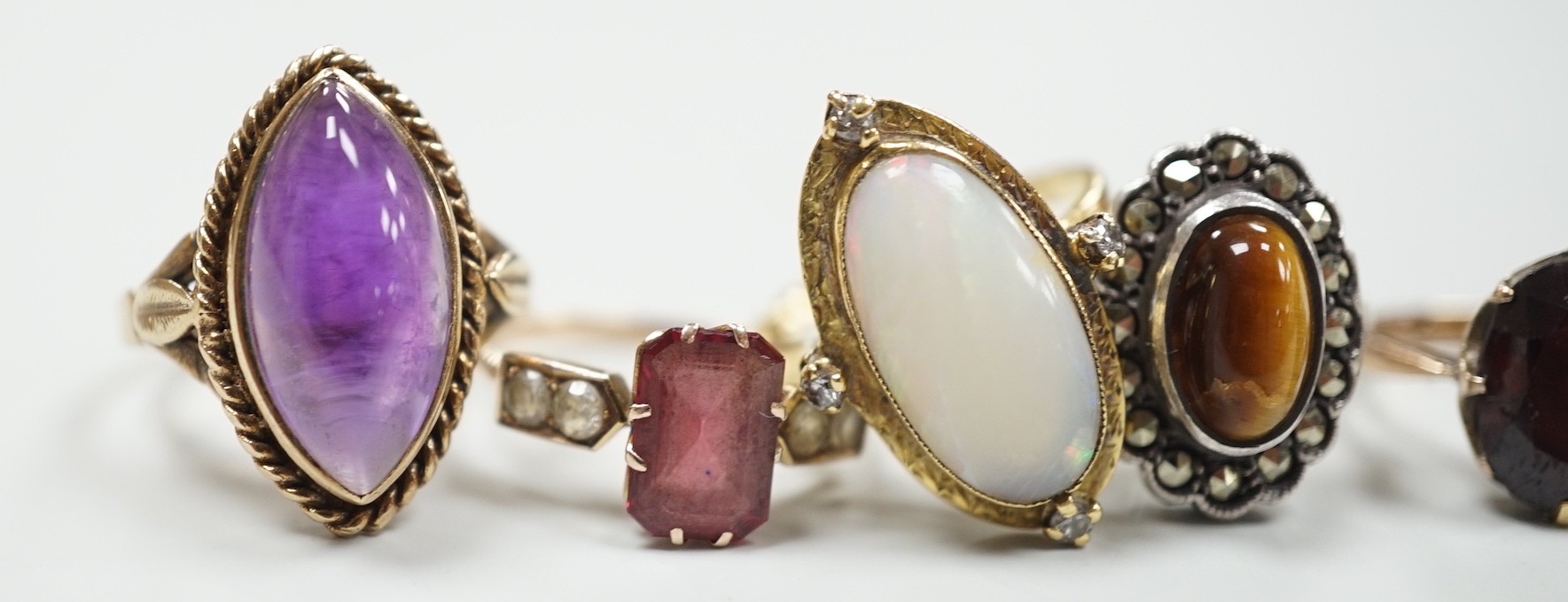 An 18ct, white opal and diamond chip set oval dress ring, size M, gross 4.8 grams and three other assorted 9ct gold and gem set dress rings, gross 10.3 grams and a white metal ring.